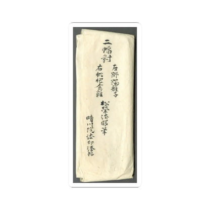 Folded cream paper wrapper on a grey backdrop, marked with several columns of handwritten black ink labels.